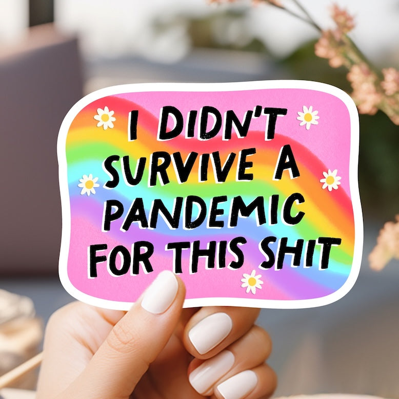 a person holding a sticker that says i didn't survive a pande