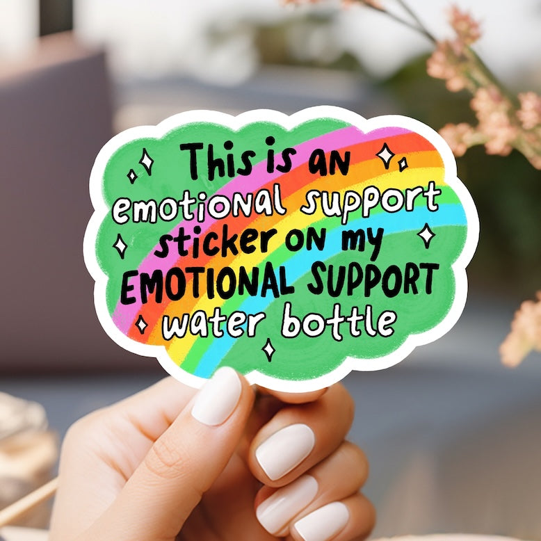 a person holding a sticker that says, this is an emotionally support sticker