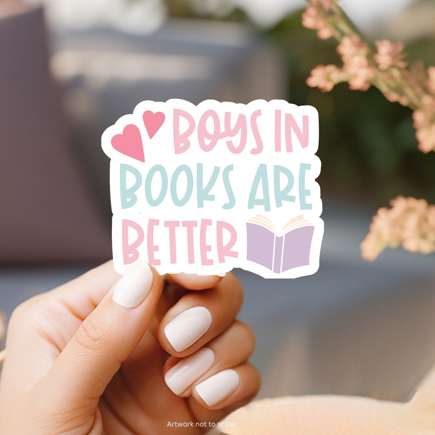 a person holding a sticker that says boys in books are better