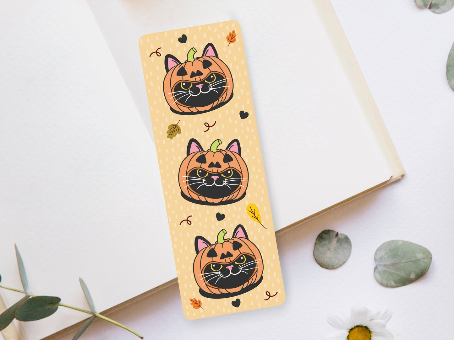 Bookmark of a Black Cat wearing a pumpkin hat.