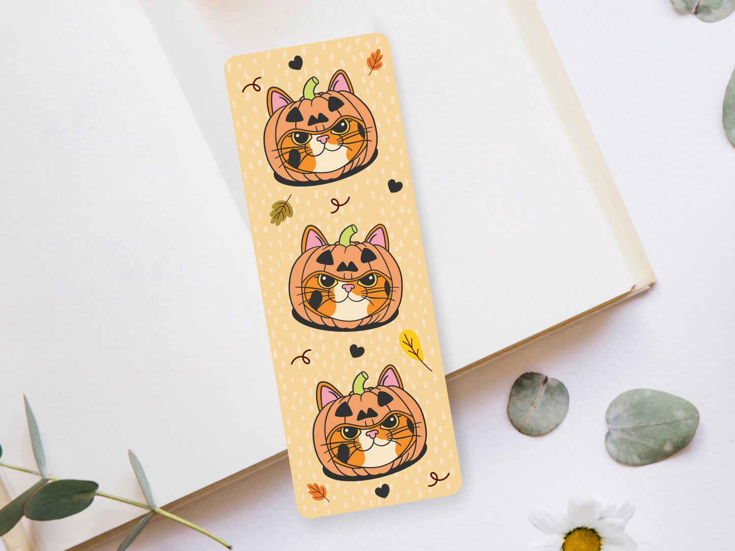 Bookmark of a Calico Cat wearing a pumpkin hat.