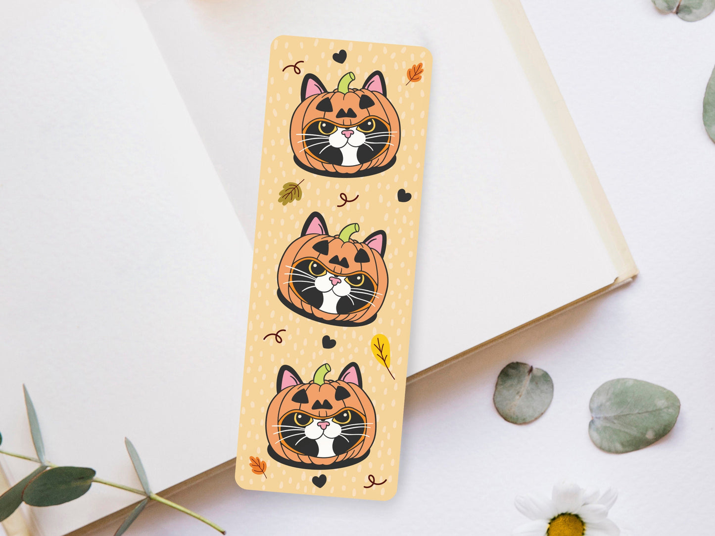 Bookmark of a Tuxedo Cat wearing a pumpkin hat.