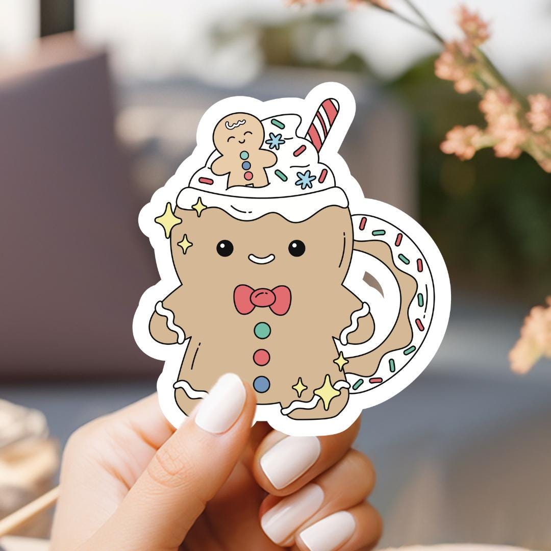 a person holding up a sticker with a cat on it