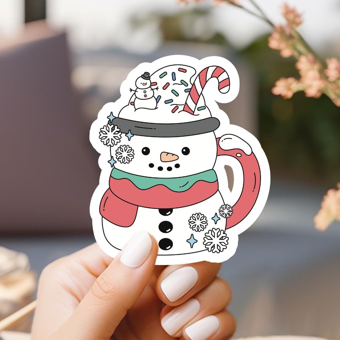 a person holding a sticker with a snowman on it