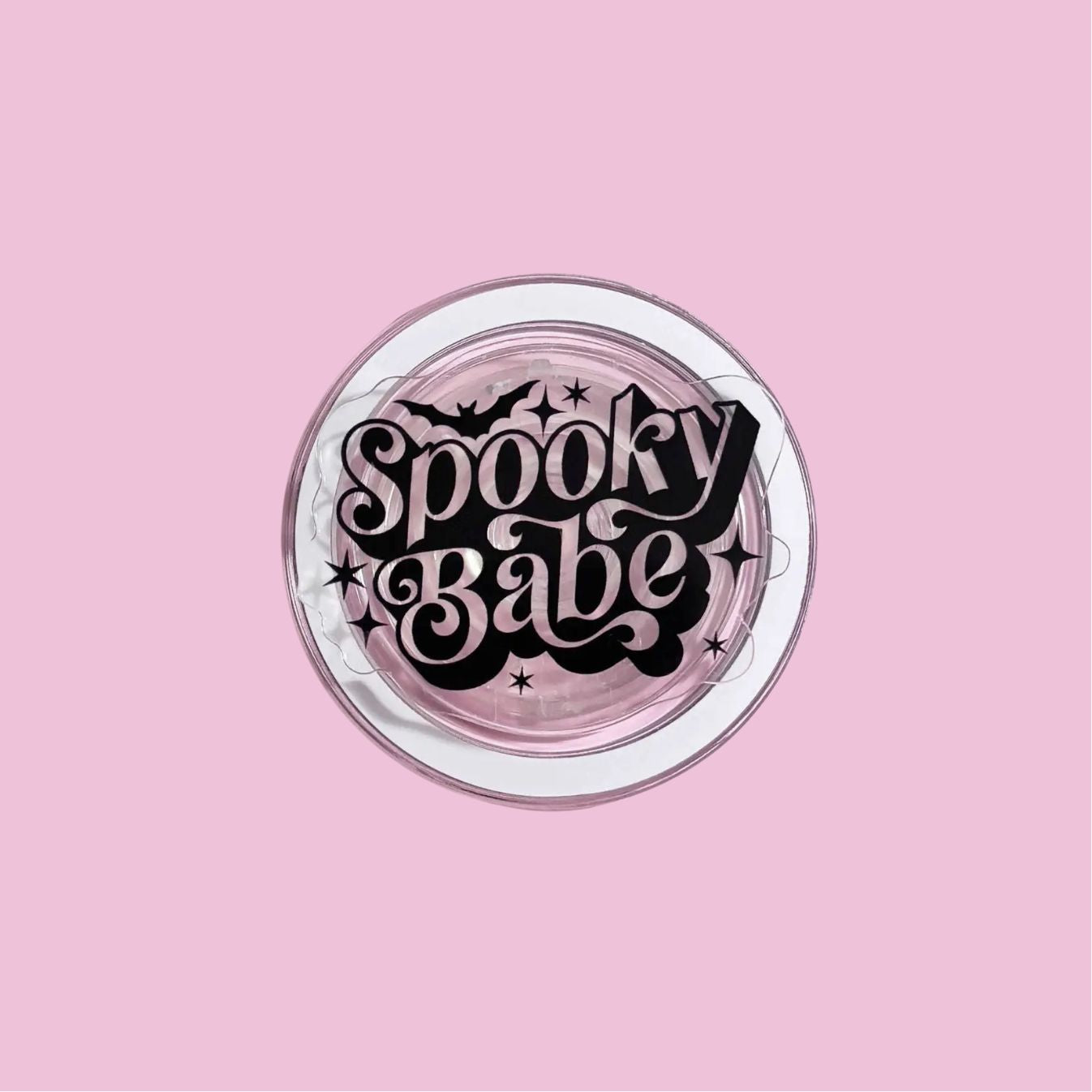 A pink background with a circular design featuring the text "Spooky Babe" in a stylized font.