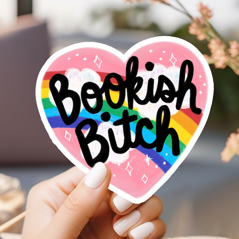 a person holding a heart shaped sticker with the word boof bitch on it