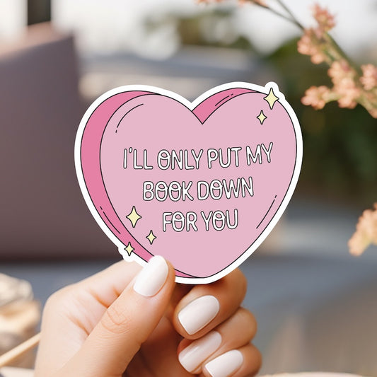 a woman holding a pink heart shaped sticker with the words i'll only