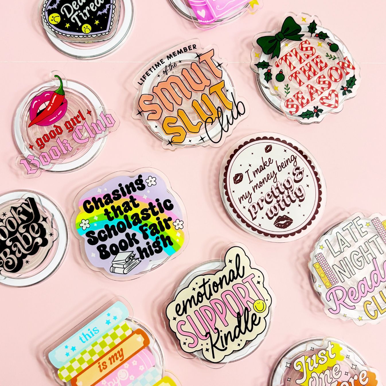 a collection of colorful stickers or magnets with various texts and designs, including phrases and logos related to clubs, books, and personal interests.