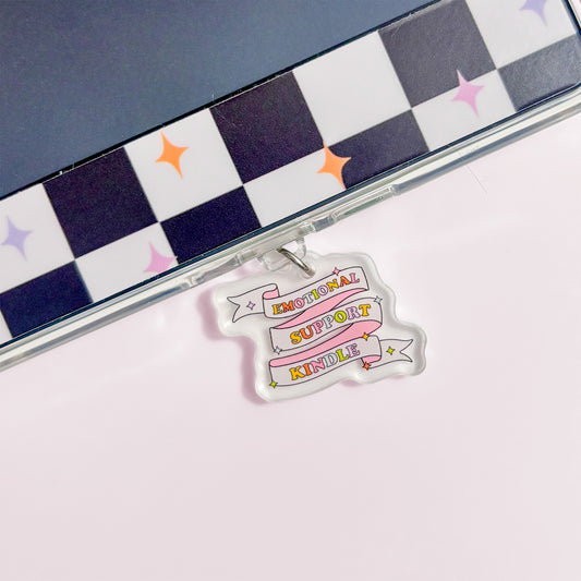 a clear plastic charm with a colorful design hanging from a surface.