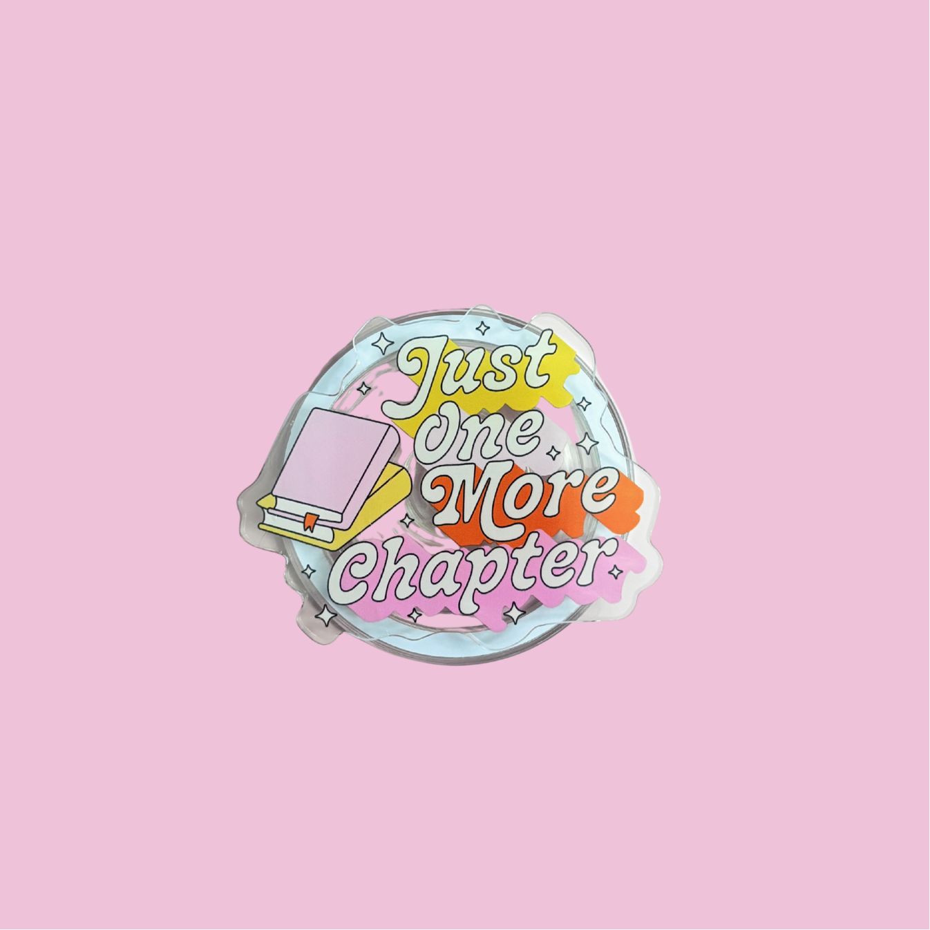 A sticker with the text "Just one more chapter" and a book icon, set against a pink background.
