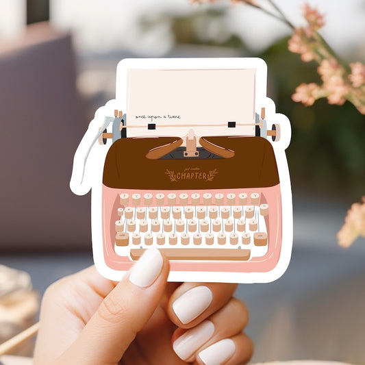 a person holding a paper cut out of a typewriter
