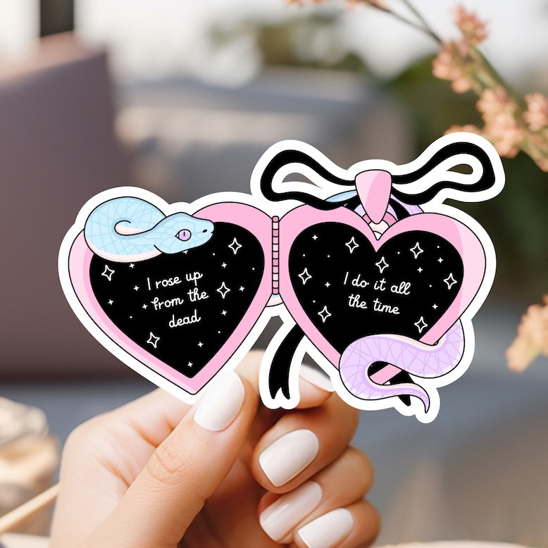 a person holding up a sticker with two hearts