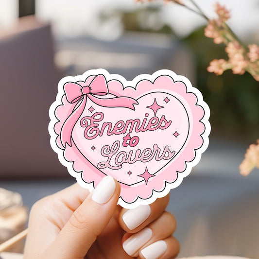 a person holding a pink heart shaped sticker