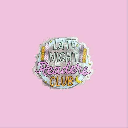 A sticker with the text "LATE NIGHT READERS CLUB" and various decorative elements such as stars and a crescent moon.
