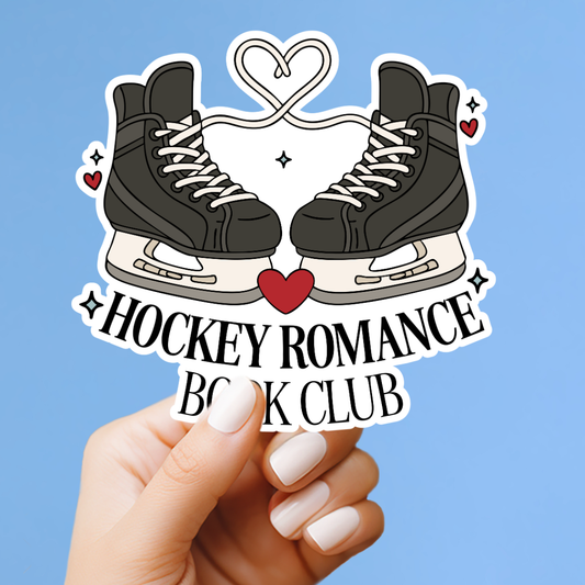 A hand holding a sticker with a pair of ice skates and a heart symbol, along with the text "Hockey Romance Book Club".