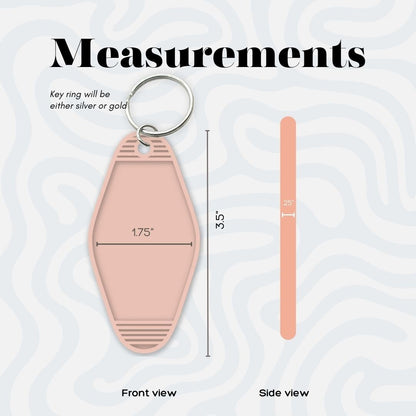 a pink keychain with measurements on it