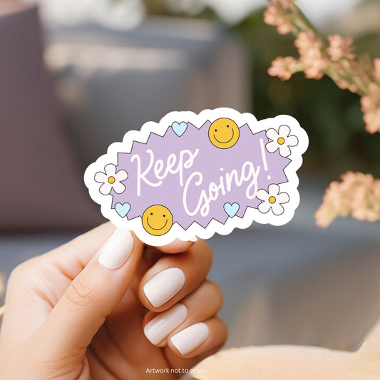 a person holding a sticker with a smiley face on it