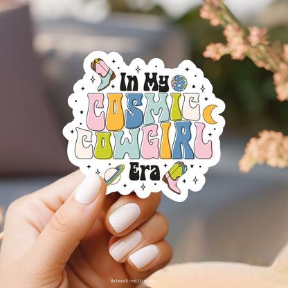 a hand holding a sticker that says in my cosmic world