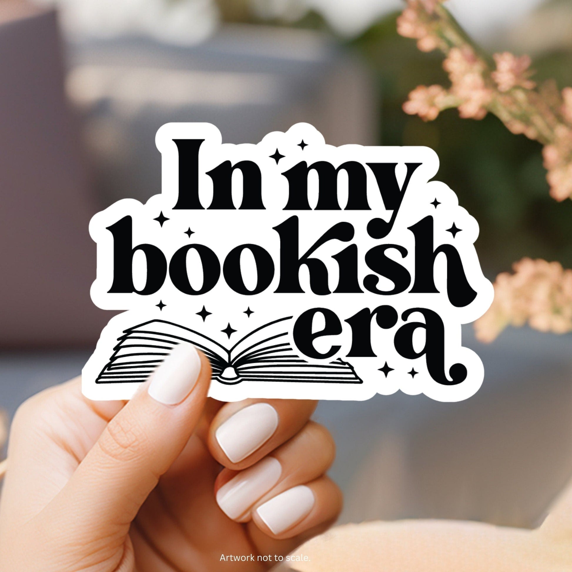 a person holding up a sticker that says i&#39;m my bookish era