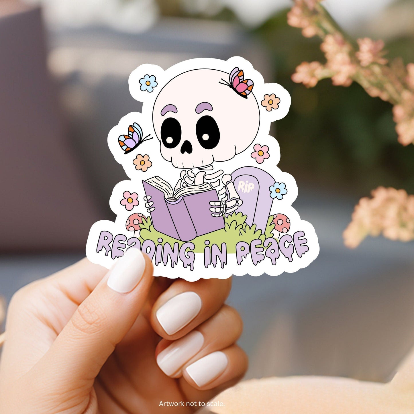 a sticker of a skeleton reading a book