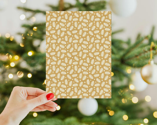 a person holding a Kindle Insert in front of a christmas tree