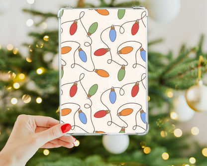 a hand holding a tablet with a christmas tree in the background