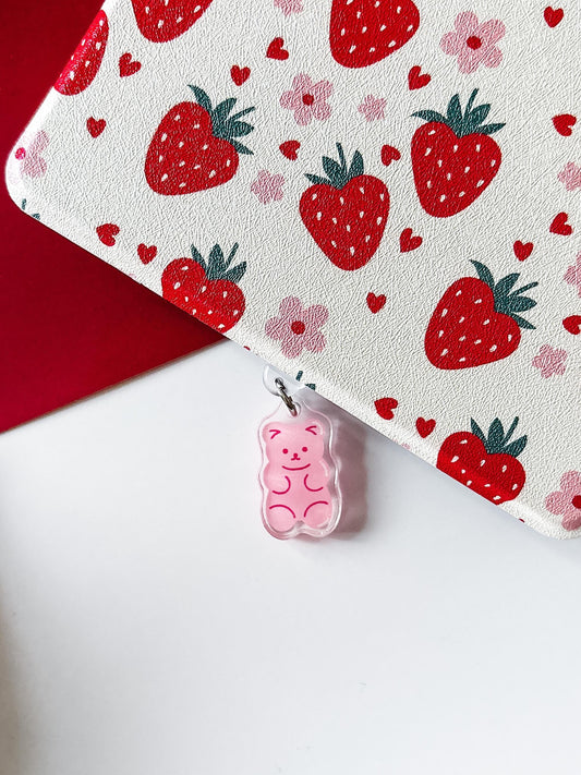 a pair of earrings with a strawberry pattern on them