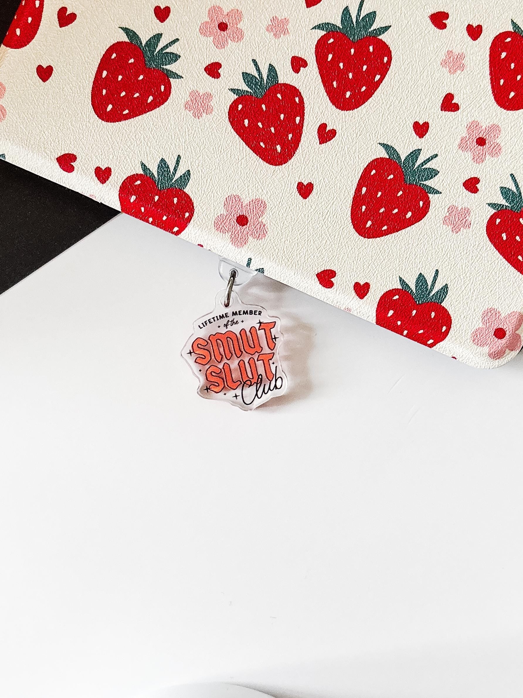 a white table with a red strawberry pattern on it