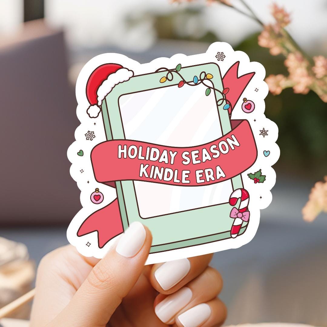 a hand holding a holiday season kindle era sticker