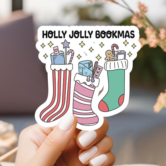 a person holding up a sticker with christmas stockings