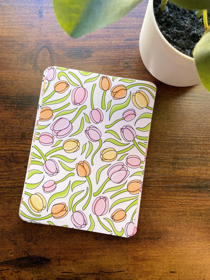 a potted plant sitting next to a notebook on a table