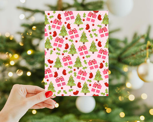 a person holding a Kindle Insert in front of a christmas tree