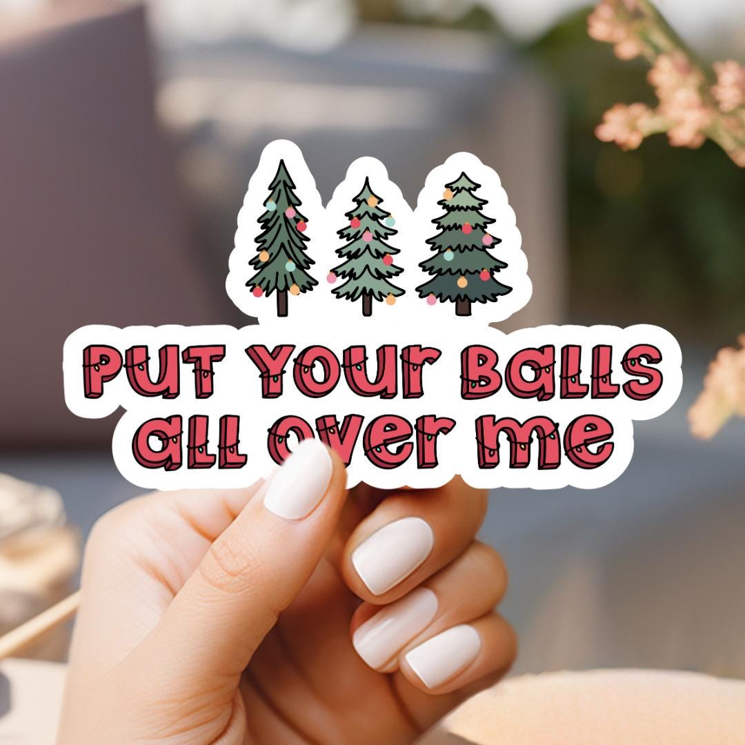 a person holding a sticker that says put your balls all over me