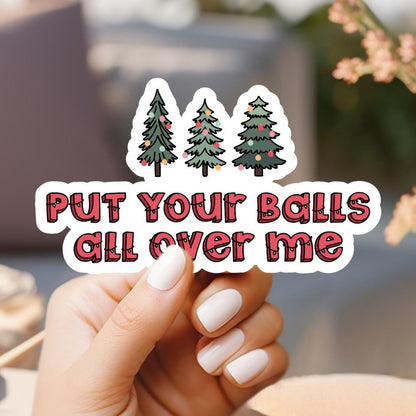 a person holding a sticker that says put your balls all over me