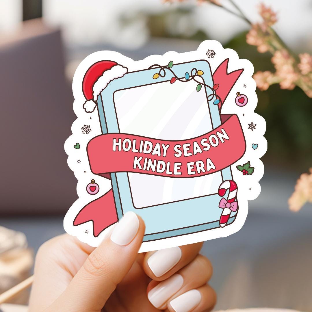 a hand holding a holiday season kindle era sticker